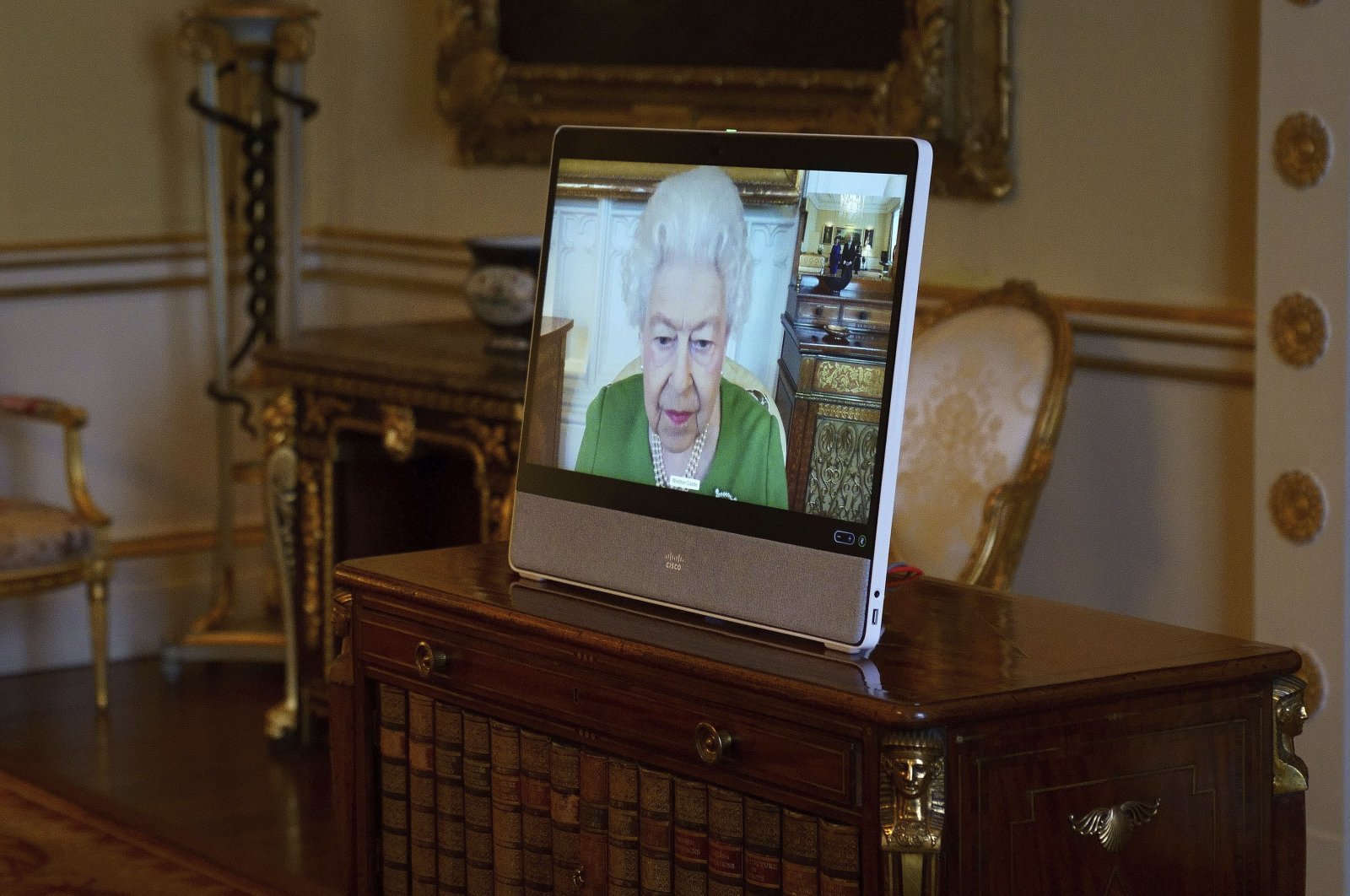 Queen Elizabeth II appears on a screen via videolink from Windsor Castle during a virtual audience to receive the Ambassador of Andorra Carles Jordana Madero at Buckingham Palace, London, U.K., March 1, 2022. (Pool Photo via AP)