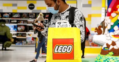A customer uses his phone while shopping in the 5th Avenue Lego store in New York City, U.S., Sept. 28, 2021. (Reuters Photo)