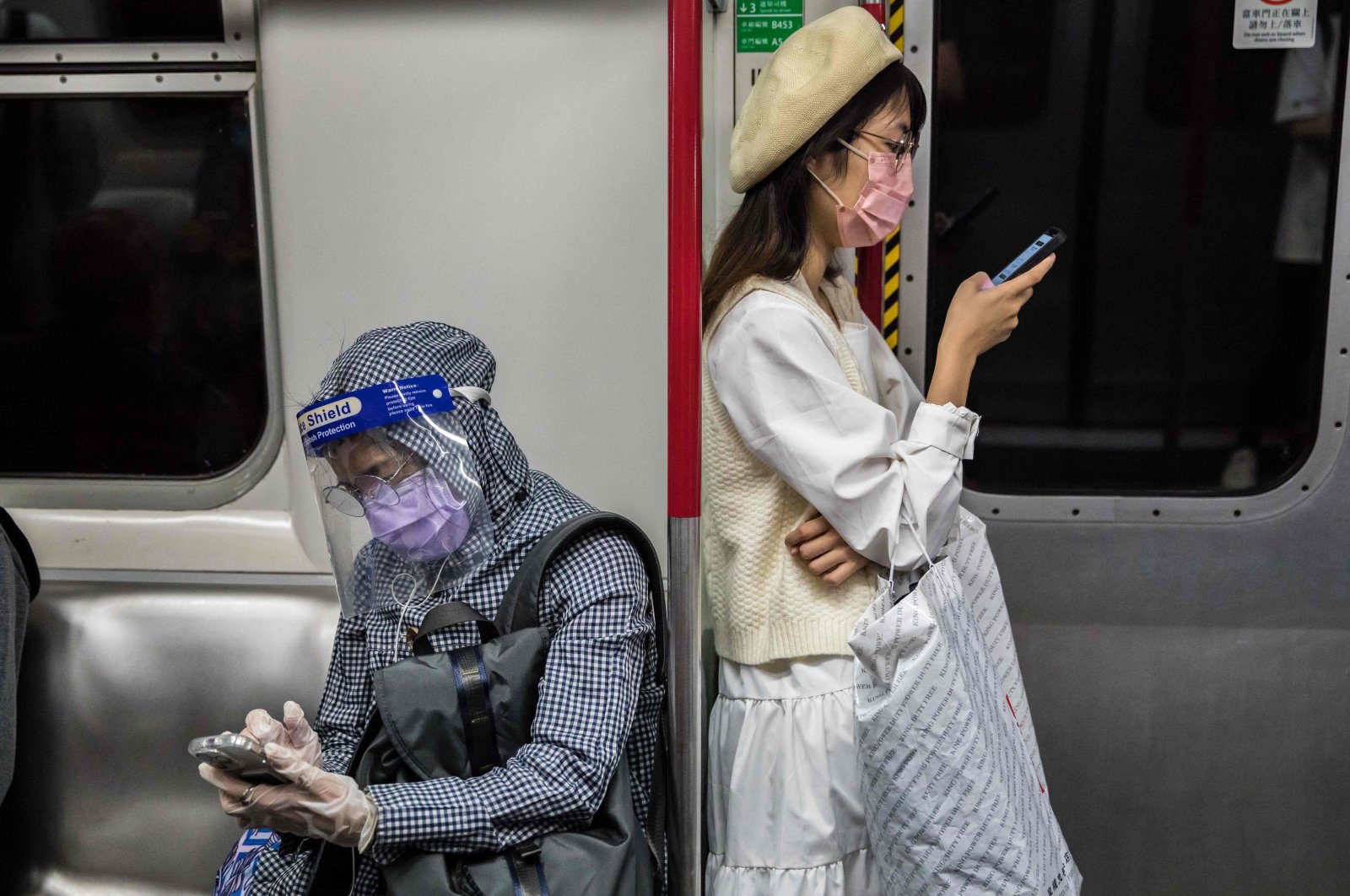 People wear face masks as a preventive measure against COVID-19 during a commute on a train in Hong Kong, March 2, 2022. (AFP Photo)
