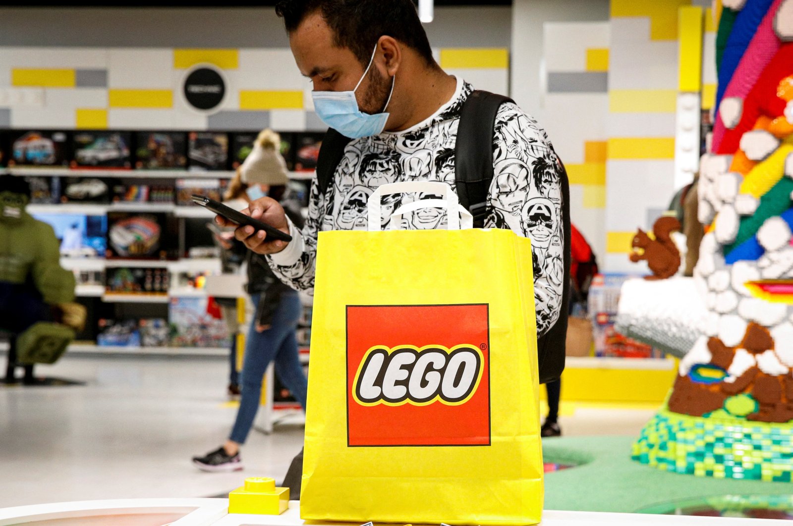 A customer uses his phone while shopping in the 5th Avenue Lego store in New York City, U.S., Sept. 28, 2021. (Reuters Photo)