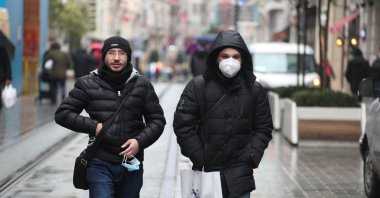 People with and without protective masks against COVID-19 walk on Istiklal Avenue, in Istanbul, Turkey, March 3, 2022. (DHA Photo)