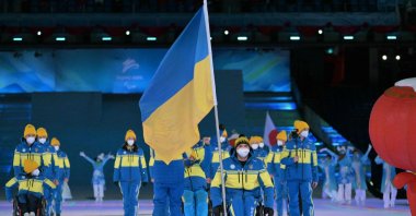 Ukrainian flagbearer Maksym Yarovyi leads the Ukraine delegation in the athlete&#039;s parade during the Beijing 2022 Winter Paralympic Games opening ceremony, Beijing, China, March 4, 2022. (AFP Photo)
