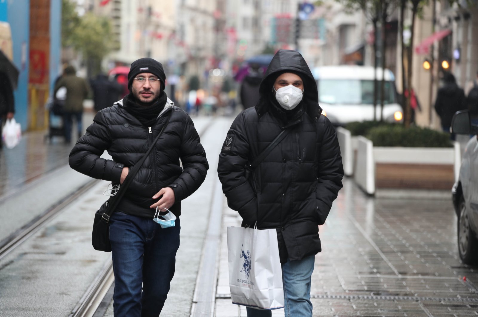 People with and without protective masks against COVID-19 walk on Istiklal Avenue, in Istanbul, Turkey, March 3, 2022. (DHA Photo)