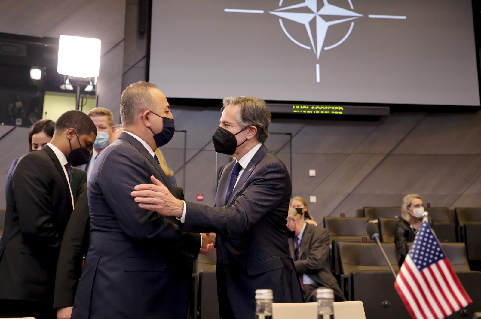Foreign Minister Mevlüt Çavuşoğlu (L) and U.S. Secretary of State Antony J. Blinken greet each other during an extraordinary NATO foreign ministers meeting at NATO headquarters in Brussels, Belgium, March 4, 2022. (AP Photo)
