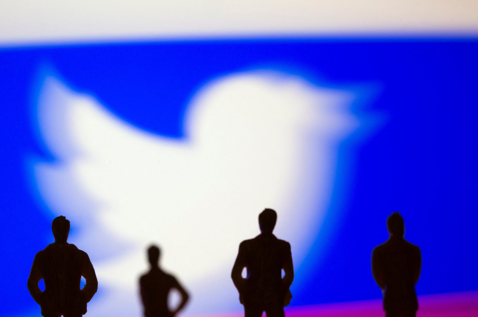 Small toy figures are seen in front of Twitter logo in this illustration picture taken March 15, 2021. (Reuters Photo)