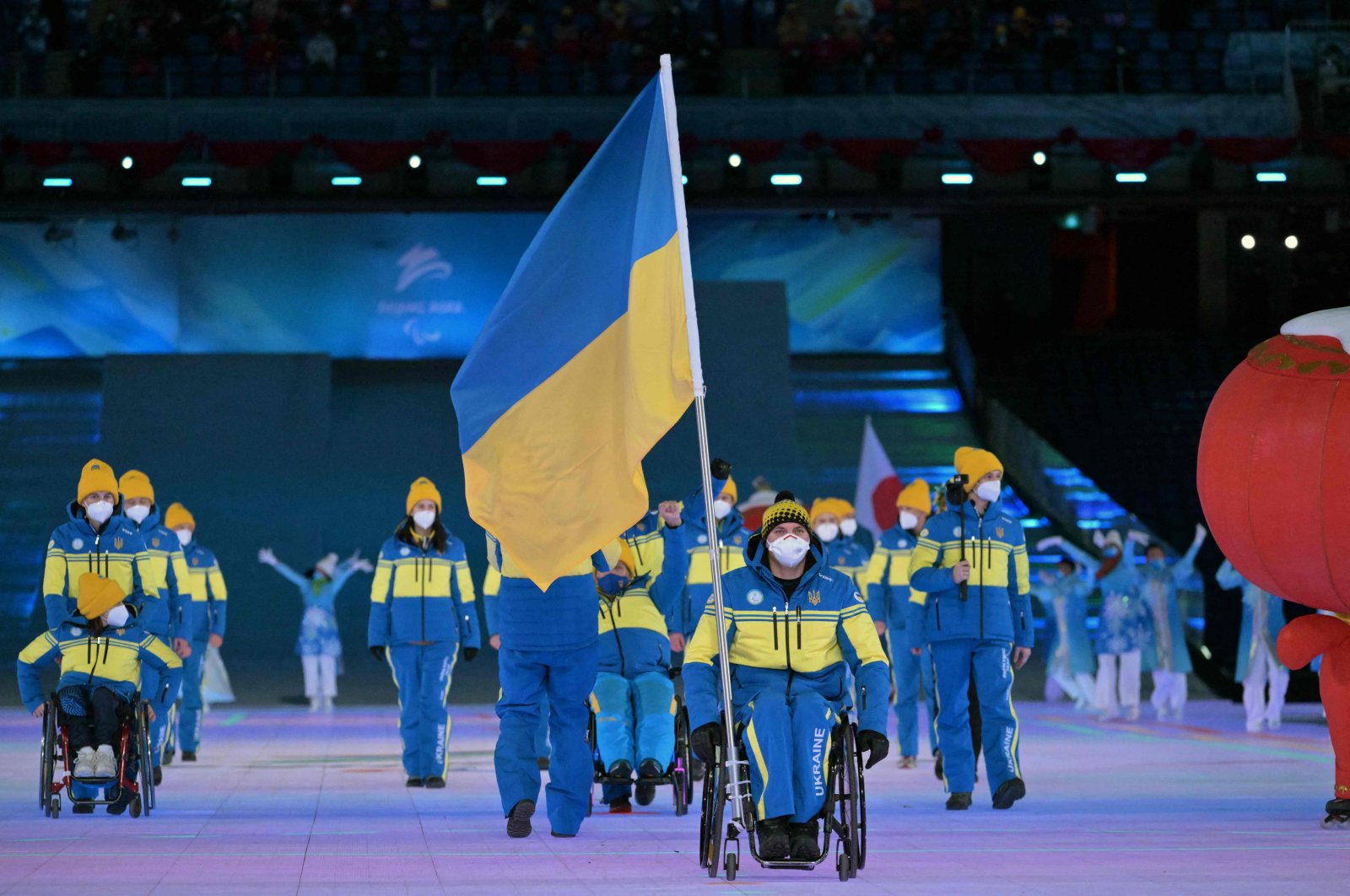 Ukrainian flagbearer Maksym Yarovyi leads the Ukraine delegation in the athlete&#039;s parade during the Beijing 2022 Winter Paralympic Games opening ceremony, Beijing, China, March 4, 2022. (AFP Photo)