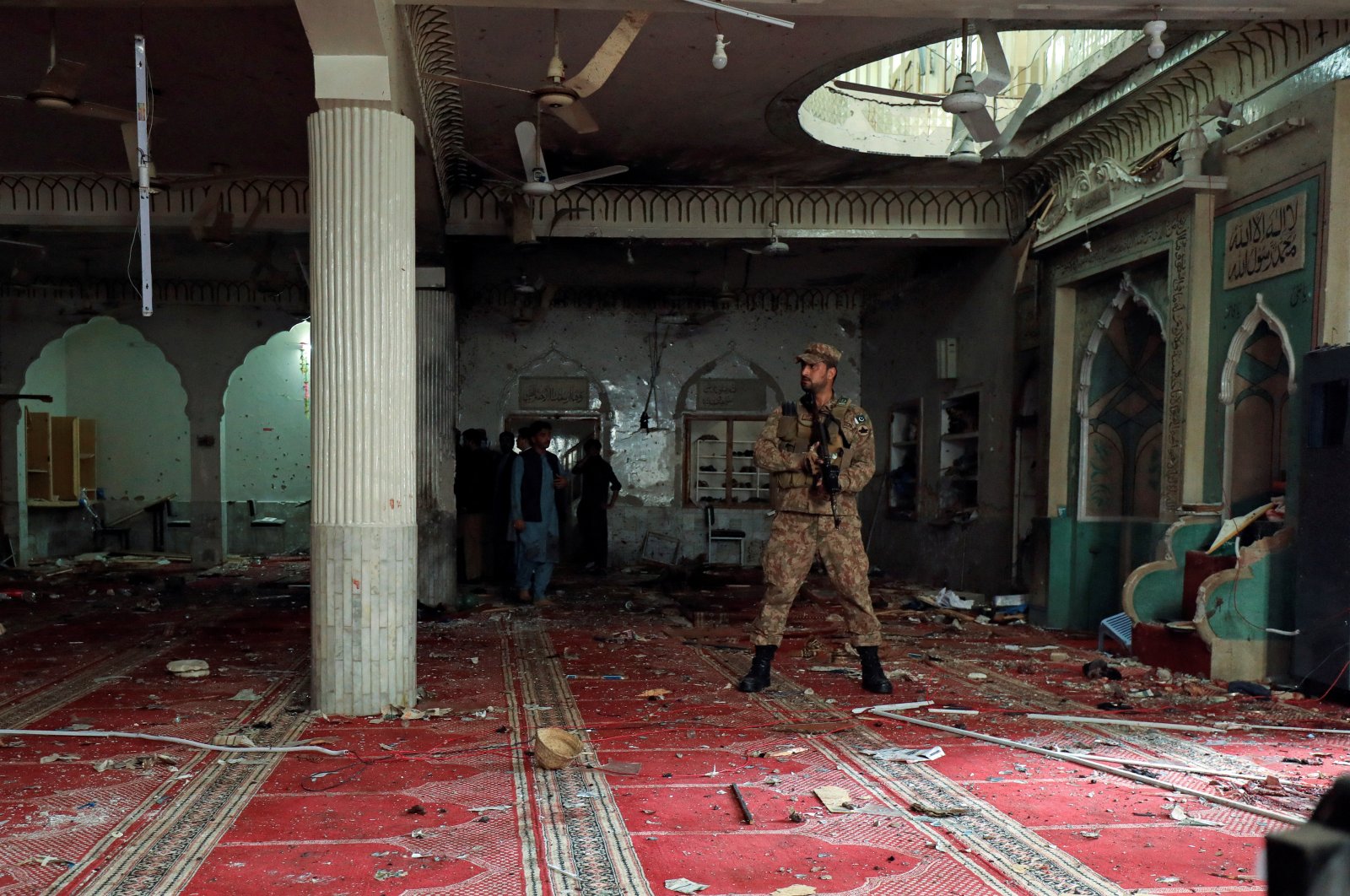 An army soldier stands amid the damages at the prayer hall after a bomb blast inside a mosque during Friday prayers in Peshawar, Pakistan, March 4, 2022. (REUTERS Photo)