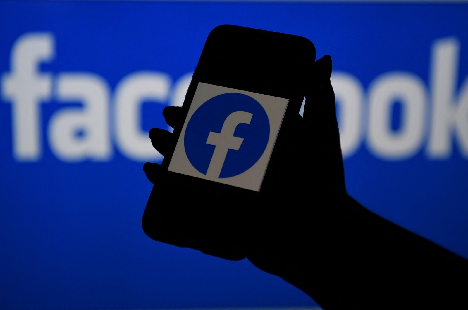 In this file photo illustration, a smart phone screen displays the logo of Facebook on a Facebook website background, on April 7, 2021, in Arlington, Virginia. (AFP Photo)