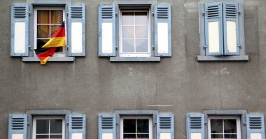 A German flag waves outside a window in this undated photo. (Reuters Photo)