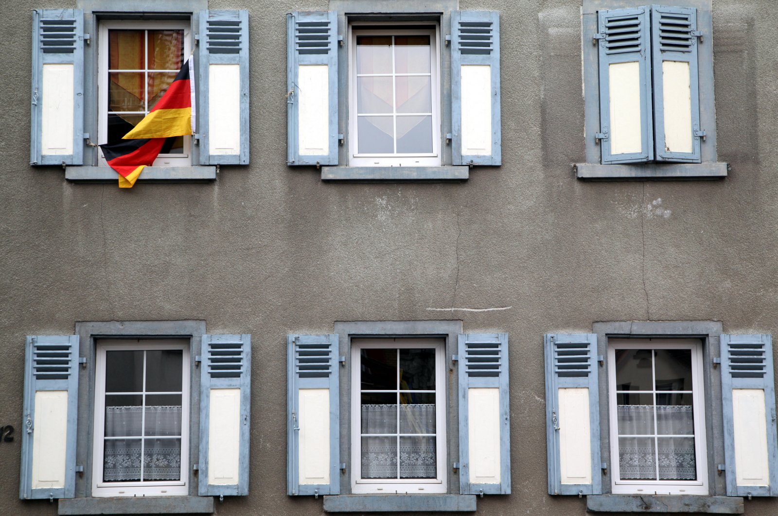 A German flag waves outside a window in this undated photo. (Reuters Photo)