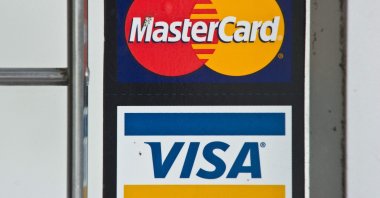 Visa and Mastercard credit card logos are seen in a store window in Washington, U.S., March 30, 2012. (AFP Photo)