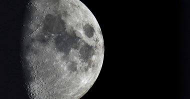 Impact craters cover the surface of the moon, seen from Berlin, Germany, Jan. 11, 2022. (AP Photo)