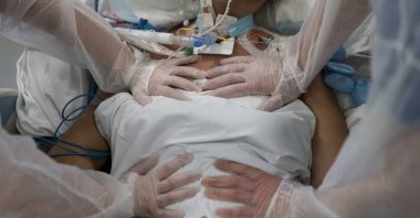 Nurses perform timed breathing exercises on a COVID-19 patient on a ventilator in the COVID-19 intensive care unit at the la Timone hospital in Marseille, southern France, Dec. 31, 2021. (AP Photo)