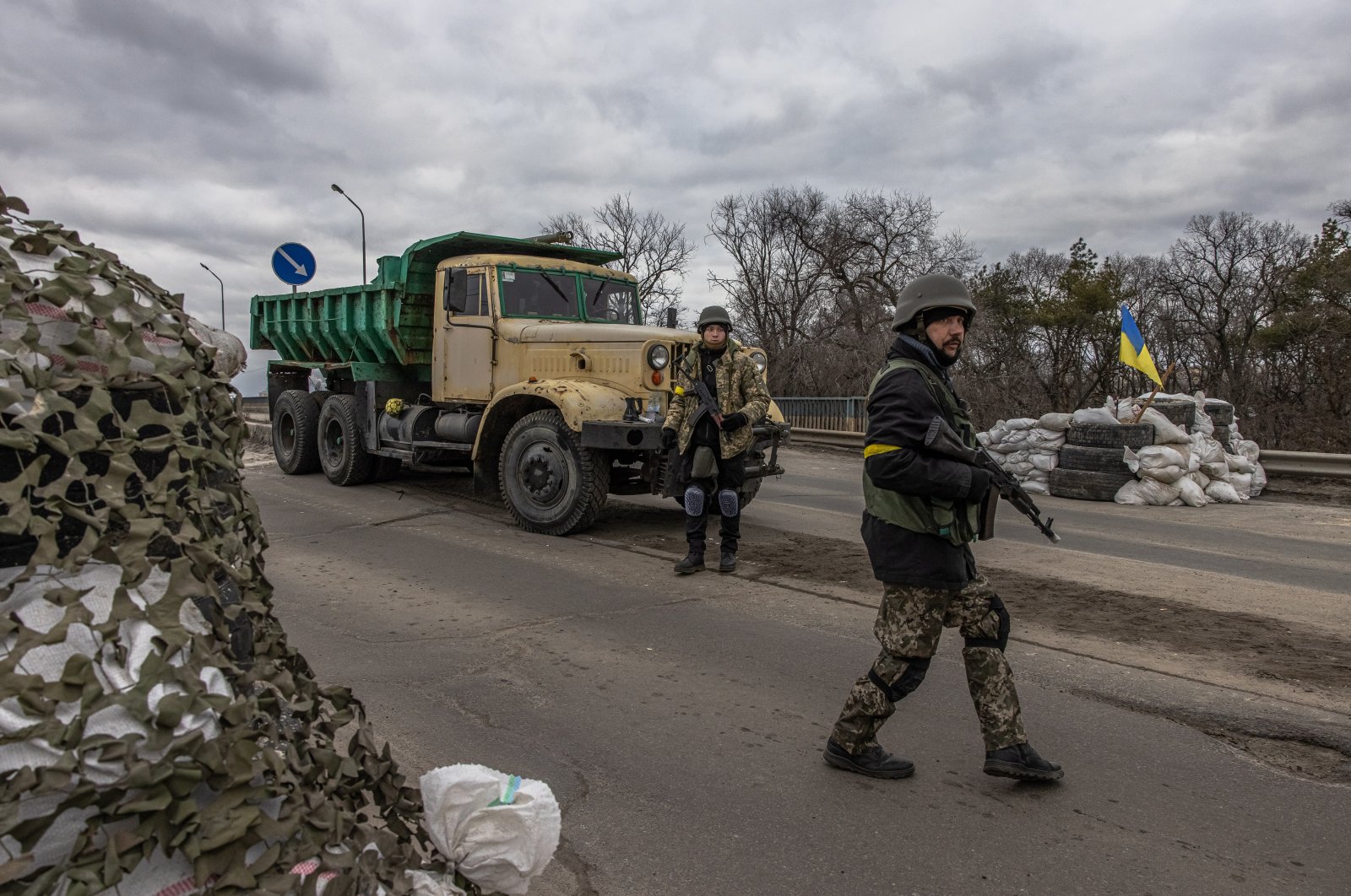 Members of the Territorial Defense Forces stand guard at a checkpoint in the eastern frontline of Kyiv region, Ukraine, 05 March 2022. (EPA)