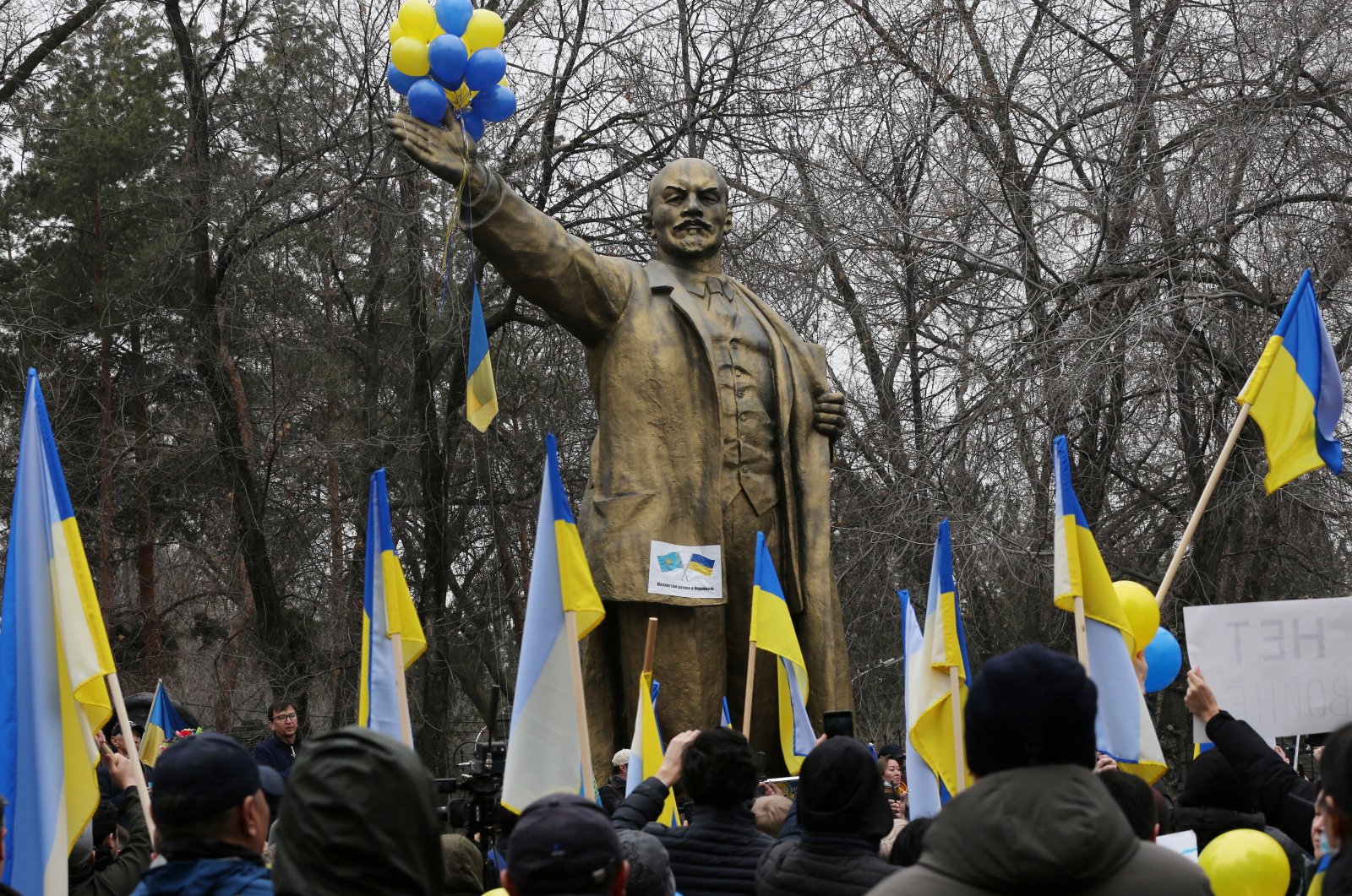 Demonstrators take part in an anti-war protest in support of Ukraine amid the Ukraine-Russia conflict, in front of the monument of Soviet state founder Vladimir Lenin in Almaty, Kazakhstan, March 6, 2022. (Reuters Photo)