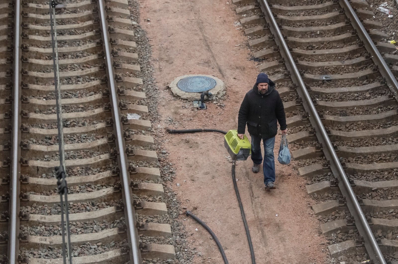 A man walks through railroad tracks to board an evacuation train from Kyiv to Lviv, at Kyiv central train station, amid Russia&#039;s invasion of Ukraine, in Kyiv, Ukraine, March 6, 2022. (Reuters Photo)