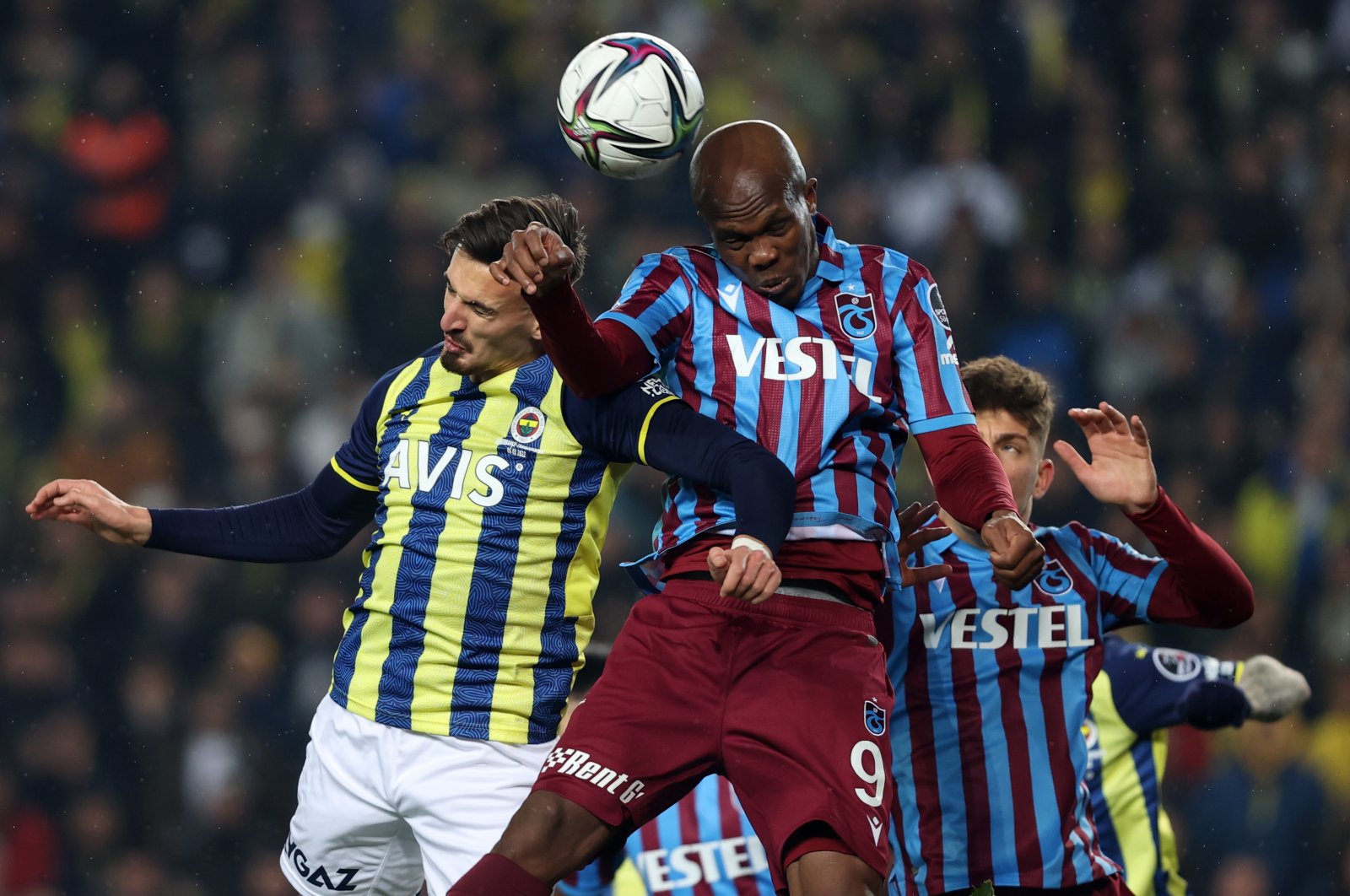 Fenerbahçe forward Mergim Berisha (L) and Anthony Nwakaeme (R) attempt to head the ball, during a Süper Lig match between Fenerbahçe and Trabzonspor at the Ülker Stadium, in Istanbul, Turkey, March 6, 2022. (AA Photo)