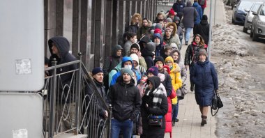 People stand in line to withdraw U.S. dollars and euros from an ATM in St. Petersburg, Russia, Feb. 25, 2022. (AP File Photo)
