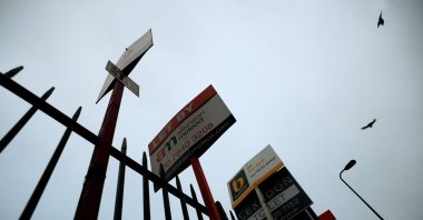 Birds take to the early morning sky as they fly over a row of estate agent signs, in London, U.K., Dec.15, 2008. (Reuters Photo)