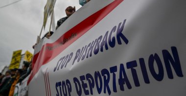 Migrants hold a banner during a protest against migrant pushbacks and border violence, near the Greek parliament in Athens, Feb. 19, 2022. (AFP Photo)