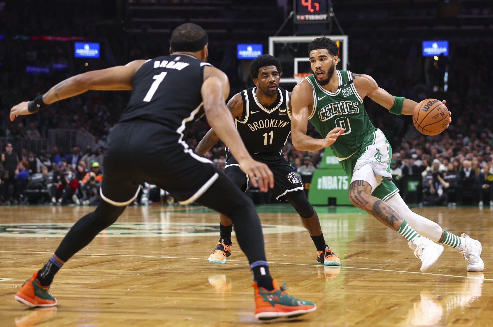 Celtics&#039; Jayson Tatum (R) drives to the basket past Nets&#039; Kyrie Irving (C) during an NBA game, Boston, Massachusetts, U.S., March 6, 2022. (AFP Photo)