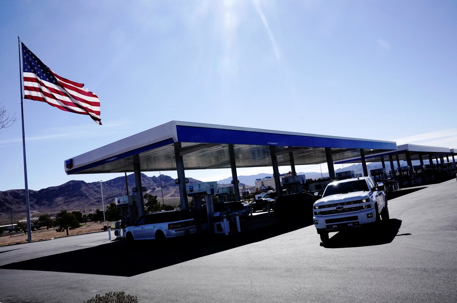 A Chevrolet pickup truck drives past fuel pumps at Terrible’s Road House, the world’s largest Chevron gas station, in Jean, Nevada, U.S., Feb. 27, 2022. (Reuters Photo)