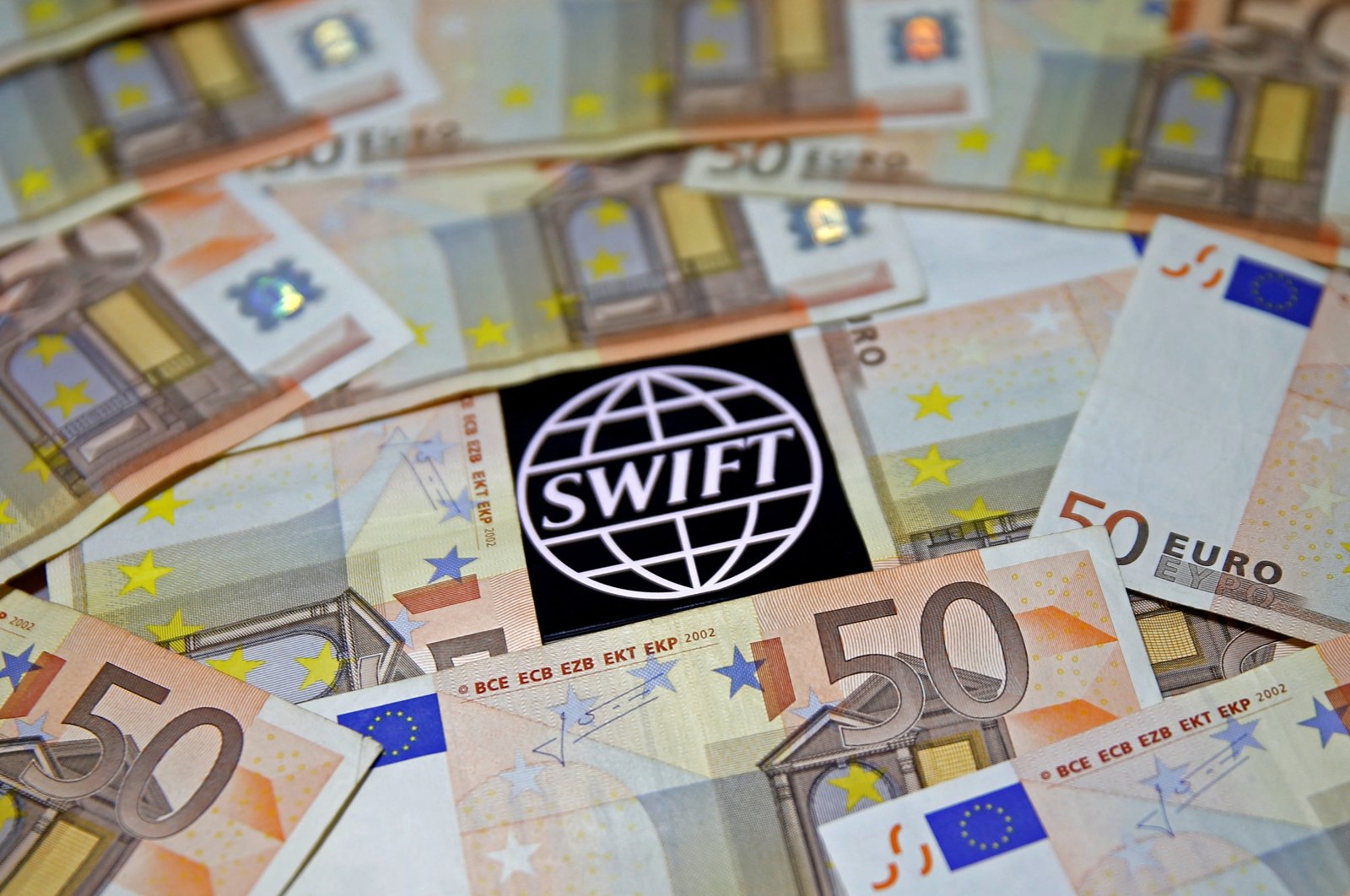 The SWIFT logo is displayed among Euro banknotes in this picture illustration, Jan. 26, 2016.  (REUTERS File Photo)