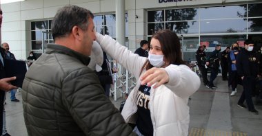 Turkish university student Buse Develi meets with her father in Antalya airport, Turkey, March 7, 2022. (IHA Photo)