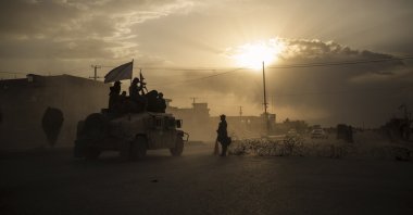 Taliban fighters ride atop a Humvee on the way to detain Afghans involved in a street fight in Kabul, Afghanistan, Sept. 21, 2021. (AP Photo)