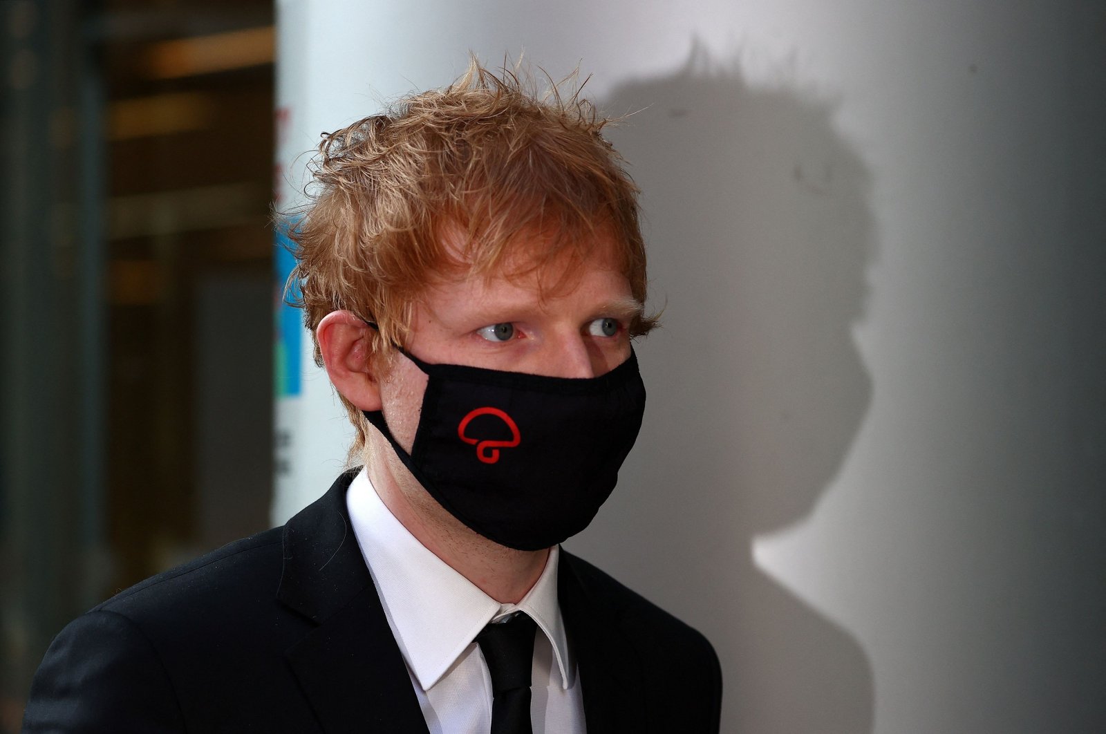 British singer-songwriter Ed Sheeran leaves from the Rolls Building of the High Court in London, on March 7, 2022 after attending the second day of a copyright trial over allegations that his hit song &quot;Shape of You&quot; has similarities to a song written by Sami Chokri and Ross O&#039;Donoghue. (AFP)