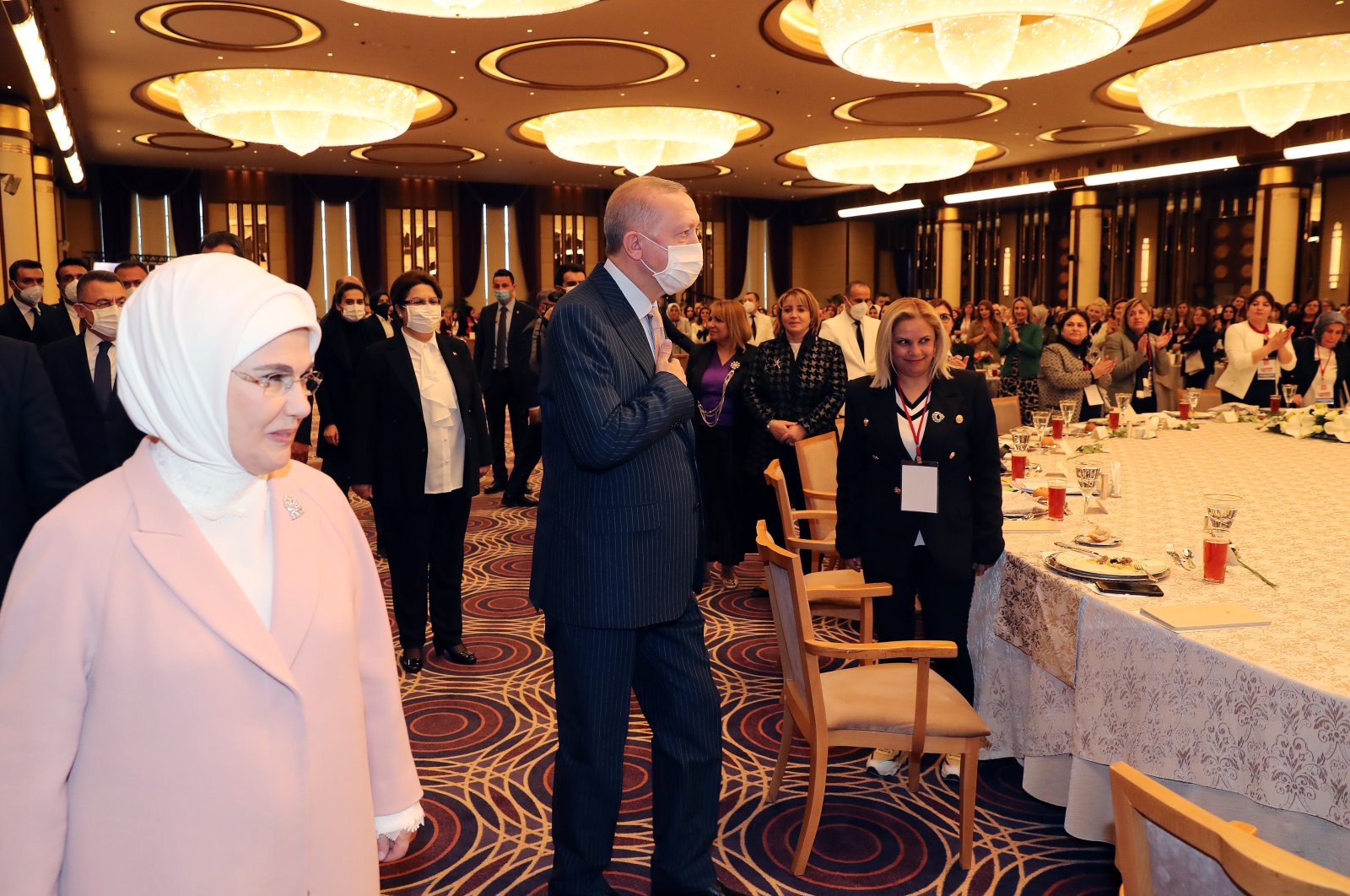 President Recep Tayyip Erdoğan (C) and first lady Emine Erdoğan (L) greet women attending the event in the capital Ankara, Turkey, March 8, 2022. (AA PHOTO)