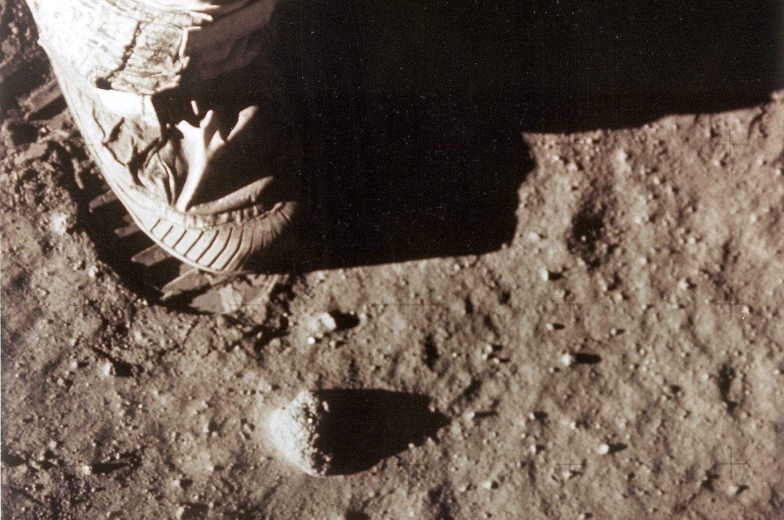 Apollo 11 commander Neil Armstrong&#039;s right foot leaves a footprint in the lunar soil as he and Edwin &quot;Buzz&quot; Aldrin become the first men to set foot on the surface of the moon, July 20, 1969. (NASA via AFP)