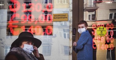 People walk past a currency exchange office in central Moscow, Russia, Feb. 28, 2022. (AFP Photo)