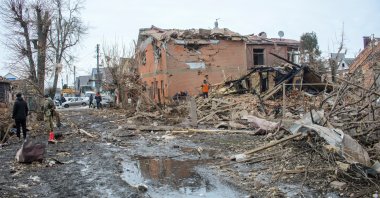 People search through debris near houses destroyed by shelling, amid Russia's invasion of Ukraine, in Sumy, Ukraine, March 8, 2022. (REUTERS)