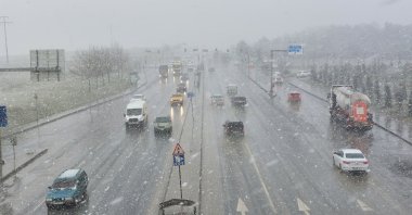 View of a busy road amid slight snowfall, in Istanbul, Turkey, March 9, 2022. (IHA PHOTO)