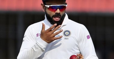 India's Virat Kohli shines the ball during a Test match against Bangladesh, Indore, India, Nov. 16, 2019. (AP Photo)