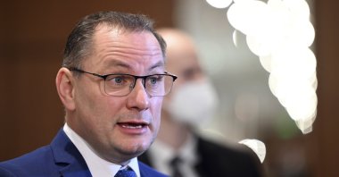 Tino Chrupalla, chairperson of AfD, gives interviews outside the courtroom in Cologne, Germany, March 8, 2022. (AP Photo)