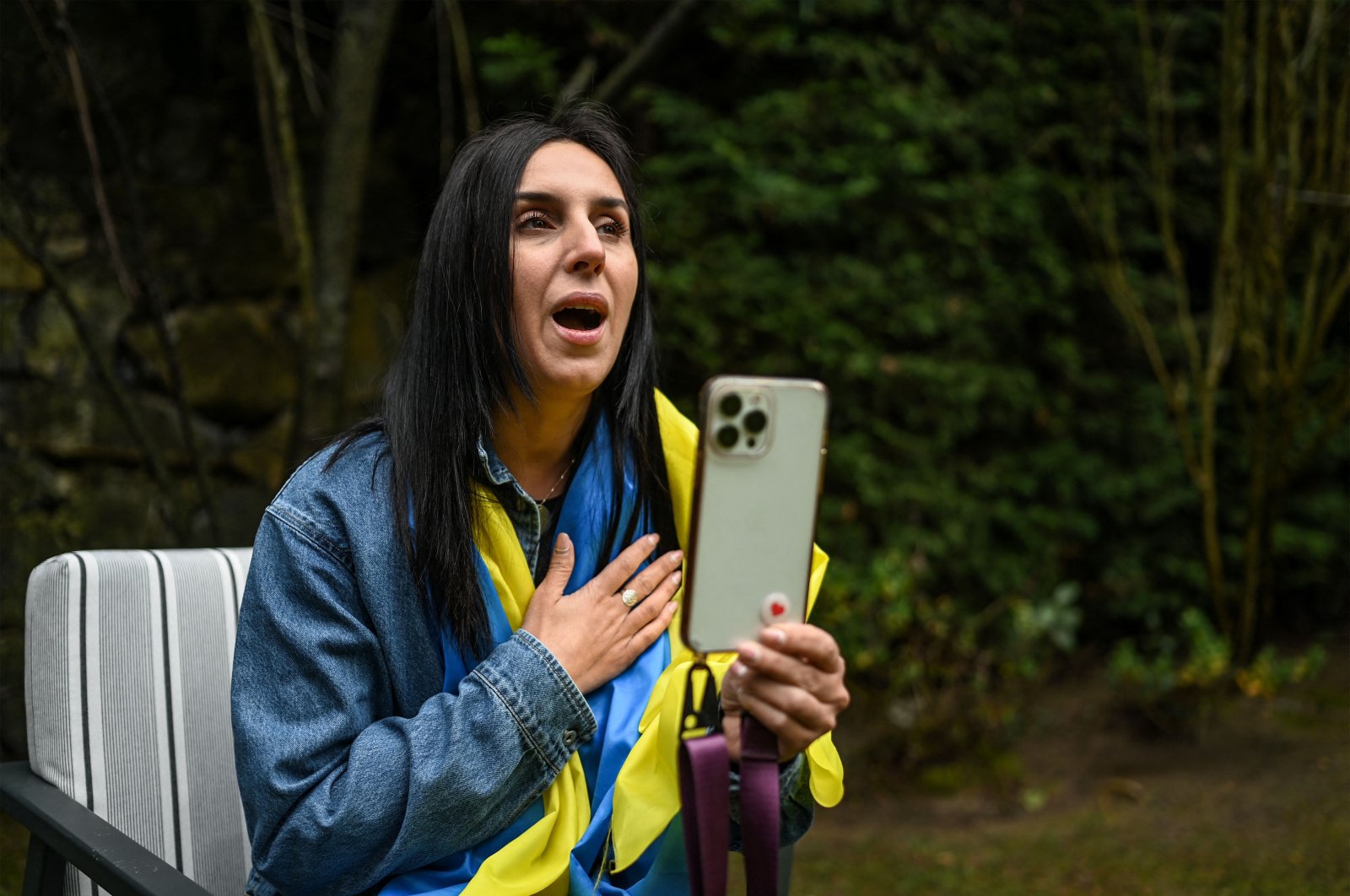 Eurovision song contest winner in 2016, Susana Jamaladinova, known as "Jamala" sings the Ukrainian national anthem to her social media followers during an AFP interview in Istanbul, March 7, 2022. (AFP)