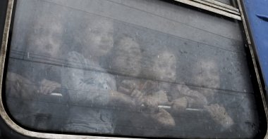 Children watch from a train carriage, waiting to leave to western Ukraine amid the Russian invasion of Ukraine, at the railway station in Kramatorsk, Ukraine, March 9, 2022. (AP Photo)