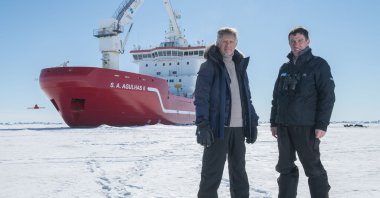 Menson Bound, director of exploration of the Endurance22 expedition (L) and John Shears, expedition leader, with SA Agulhas II in the background, on the Weddell Sea, Antarctica, Feb. 20, 2022. (Falklands Maritime Heritage Trust via AFP)