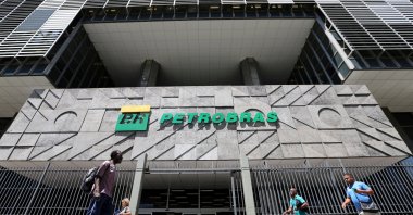 People walk in front of the headquarters of Petroleo Brasileiro S.A. (Petrobas) in Rio de Janeiro, Brazil, March 9, 2020. (Reuters Photo)