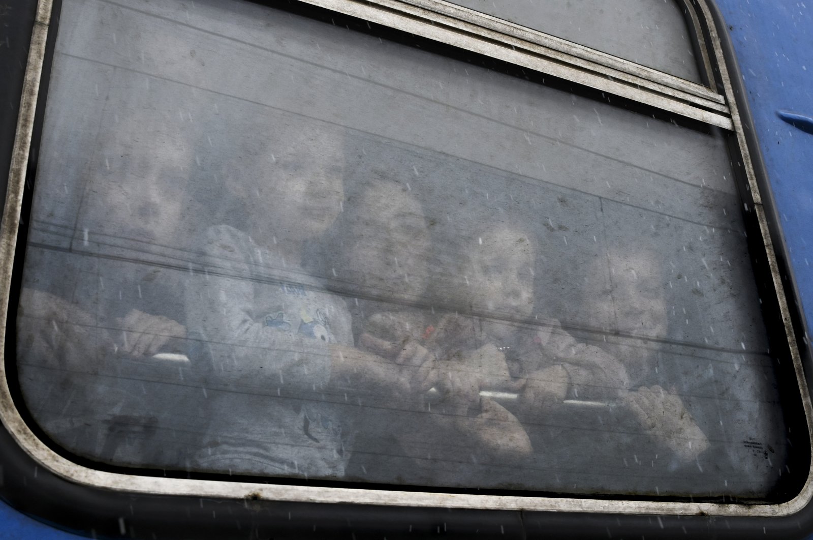 Children watch from a train carriage, waiting to leave to western Ukraine amid the Russian invasion of Ukraine, at the railway station in Kramatorsk, Ukraine, March 9, 2022. (AP Photo)