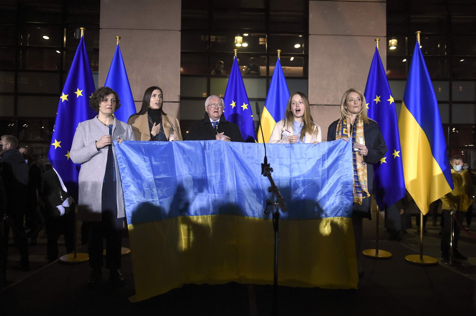 Strasbourg Mayor Jeanne Barseghian (L), Ukraine's Permanent Representative to the Council of Europe, Borys Tarasyuk (C), and European Parliament President Roberta Metsola (R) attend a demonstration in support of the Ukrainian people and against Russia's military operation in Ukraine, at the European Parliament in Strasbourg, eastern France, March 9, 2022. (AFP Photo)