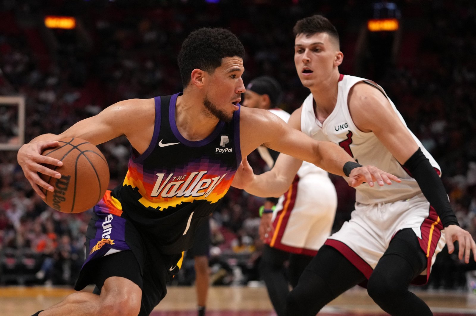 Phoenix Suns Devin Booker (L) drives the ball around Miami Heat guard Tyler Herro during an NBA game, Miami, Florida, U.S., March 9, 2022. (Reuters Photo)
