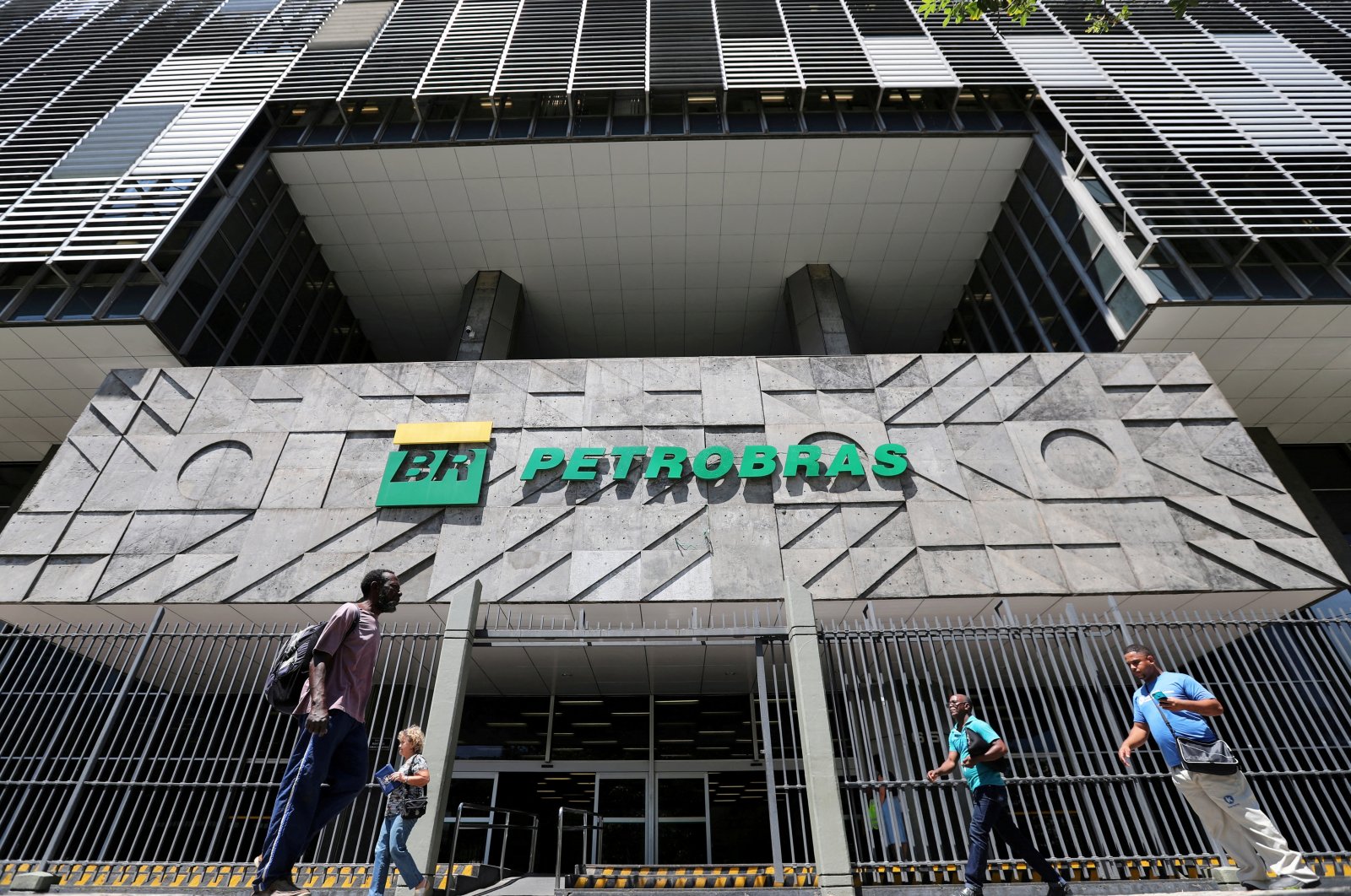People walk in front of the headquarters of Petroleo Brasileiro S.A. (Petrobas) in Rio de Janeiro, Brazil, March 9, 2020. (Reuters Photo)