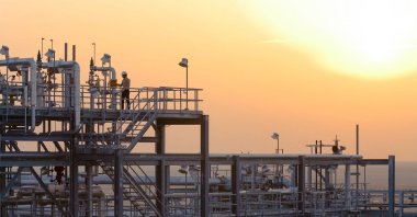 This file handout photo obtained on Jan. 29, 2011, from Energy giant Saudi Aramco shows an operator at the condensate stabilizer area at the Haradh Gas Plant, Saudi Arabia. (Photo by JOE LYNCH/Saudi Aramco via AFP)