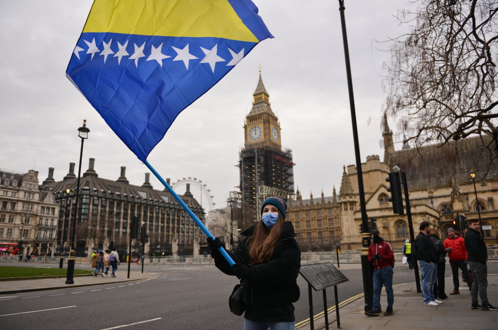 A demonstrator waves a flag during a rally to raise awareness of a potential new Bosnian crisis, at Parliament Square in London, U.K., Jan. 10, 2022. (AP Photo)