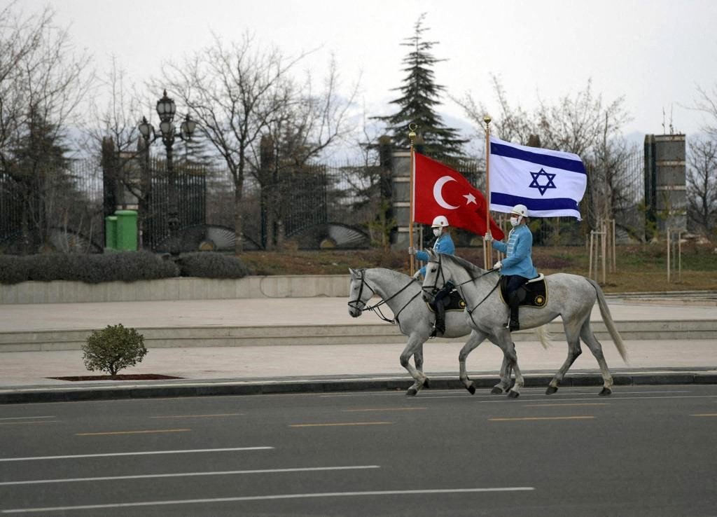 Turkish cavalry guards carrying the Turkish (L) and Israeli flags to welcome the Israeli president in the capital Ankara, Turkey, March 9, 2022. (Handout Photo by Israeli Government Press Office via AFP)