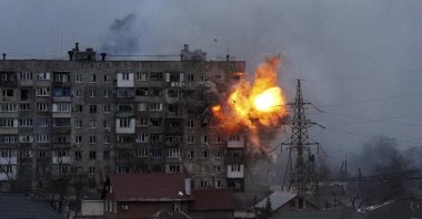 An explosion is seen in an apartment building after a Russian army tank fires in Mariupol, Ukraine, March 11, 2022. (AP Photo)