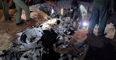 People work around the remains of a missile accidentally fired into Pakistan from India, near Mian Channu, Pakistan, March 9, 2022. (Pakistani security sources/Handout via Reuters)